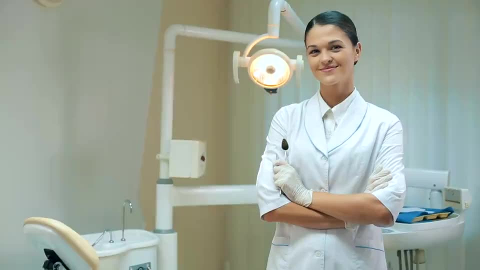 A dentist standing in her surgery