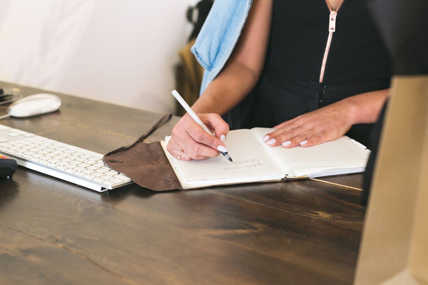A business owner writing notes at a desk