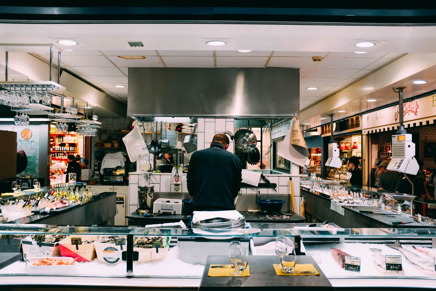 Cooks working in an open restaurant kitchen