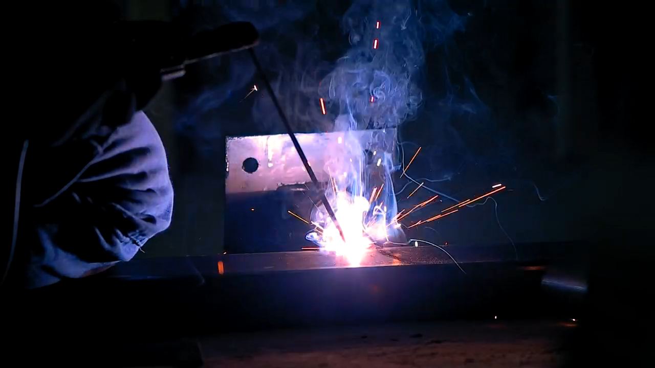 Sparks flying as a welder cuts metal